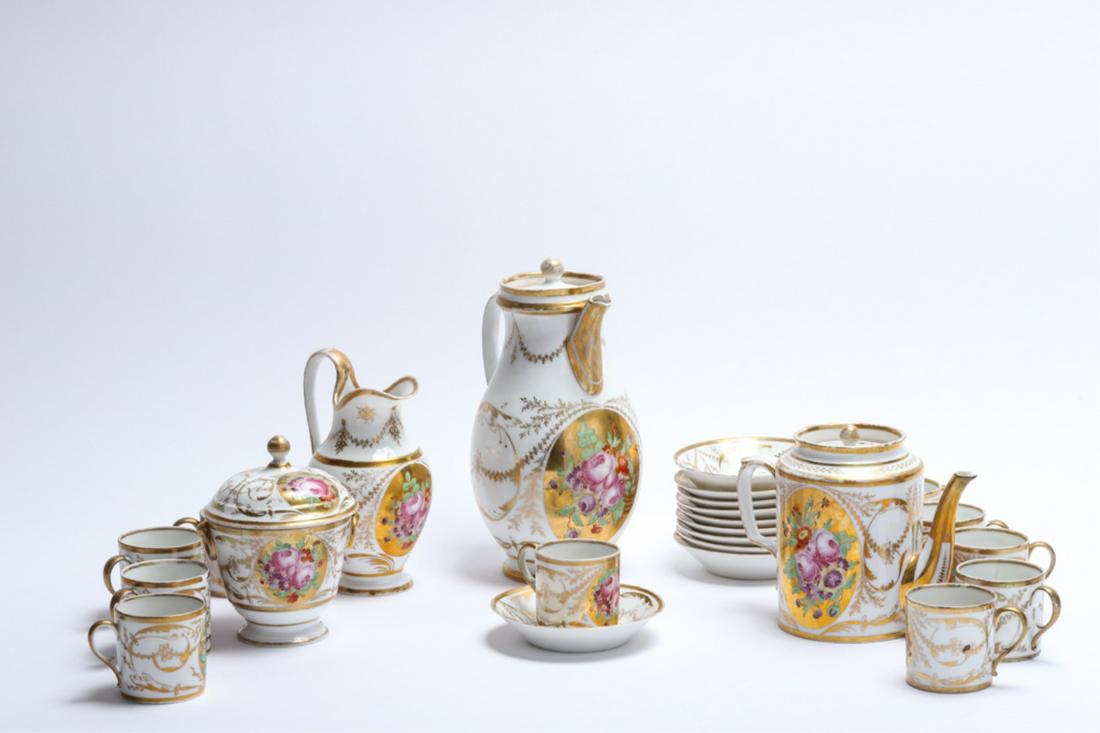 FRENCH EMPIRE PARIS PORCELAIN TEA SET: Hand painted with bouquets of flowers and swags, scrolls and wreaths of gold filigree. including: Coffee and tea pots, creamer and sugar, and (10) cups and saucers.