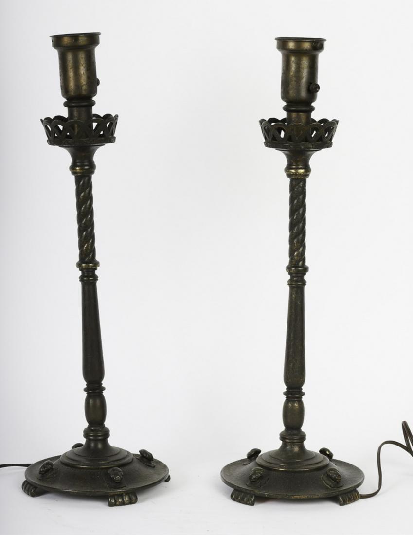 PAIR of OSCAR BACH FIGURAL BRONZE TABLE LAMPS c1920: Fitter and basket-form bobeche are supported by a rope twist post and base adorn with (4) lion heads. Each with Oscar B Bach New York brass tags under base. 23 1/3 inches with a 2 1/4 inch fitter.