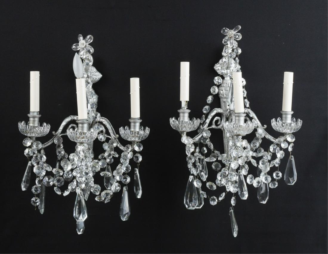 PAIR OF CAST BRONZE (3) LIGHT WALL SCONCES: Torch-form supports with scrolled arms are adorn with an elaborate array of glass flowers, luster swags, bobeches and pear drops. 17 x 14 x 9 inches