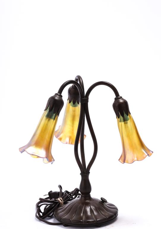 TIFFANY STYLE (3) LIGHT LILY TABLE LAMP: This lamp is not an original Tiffany and possibly Buffalo/Lundberg Studios. Gold iridescent art glass shades. Bronze base with a stamped signature over another. This is still a fine quality lamp. H. 1