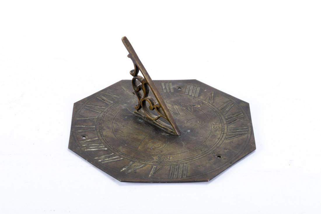 ANTIQUE BRONZE SUNDIAL "Tyme Flies": Scrolloed gnomon and engraved with the sun with a face. 3 3/8 x 7 inches.