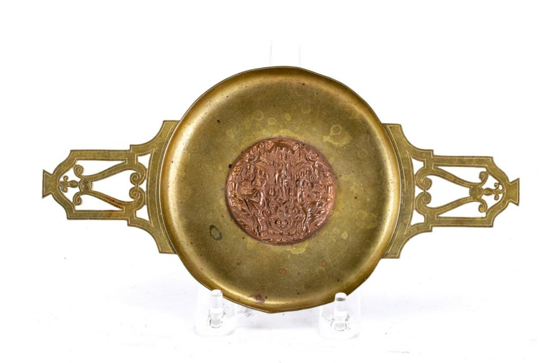E.F. CALDWELL & CO. NEW YORK BRASS & BRONZE TRAY: Two handled tray centered with bronze medallion depicting classical goddesses cast in bas relief. 8 1/2 x 4 1/2 inches.