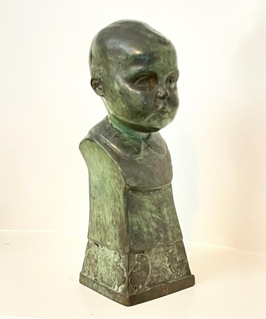 RUTH BROOKS (AMERICAN 1909-1981) BRONZE BUST: Of a child, with verde patination, the bronze continuing to a splayed socle, with a relief of chicks at the base, inscribed "1930 R. Brooks", 7 x 2.5 x 2.5 inches