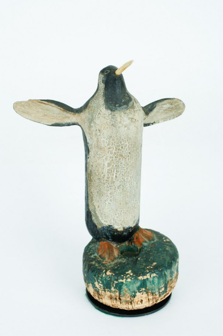 WONDERFUL FOLK ART PENGUIN: Sailor carved and decorated with a crusty dry surface, carved bill and carved flippers, mounted to a green painted net cork, late 19th to early 20th century, overall, 10 x 8 x 5 inches