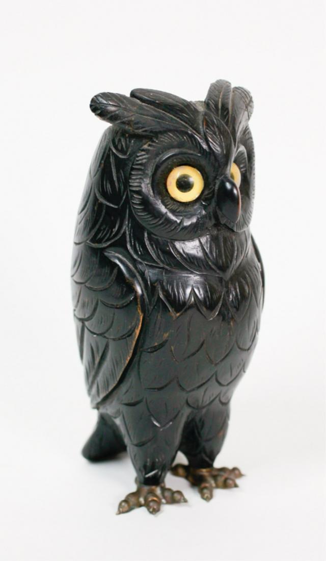CARVED EBONIZED WOOD OWL MATCH HOLDER: Late 19th to early 20th century, set with glass eyes, mounted with brass feet, (it is either a match or spill holder), 7 inches high