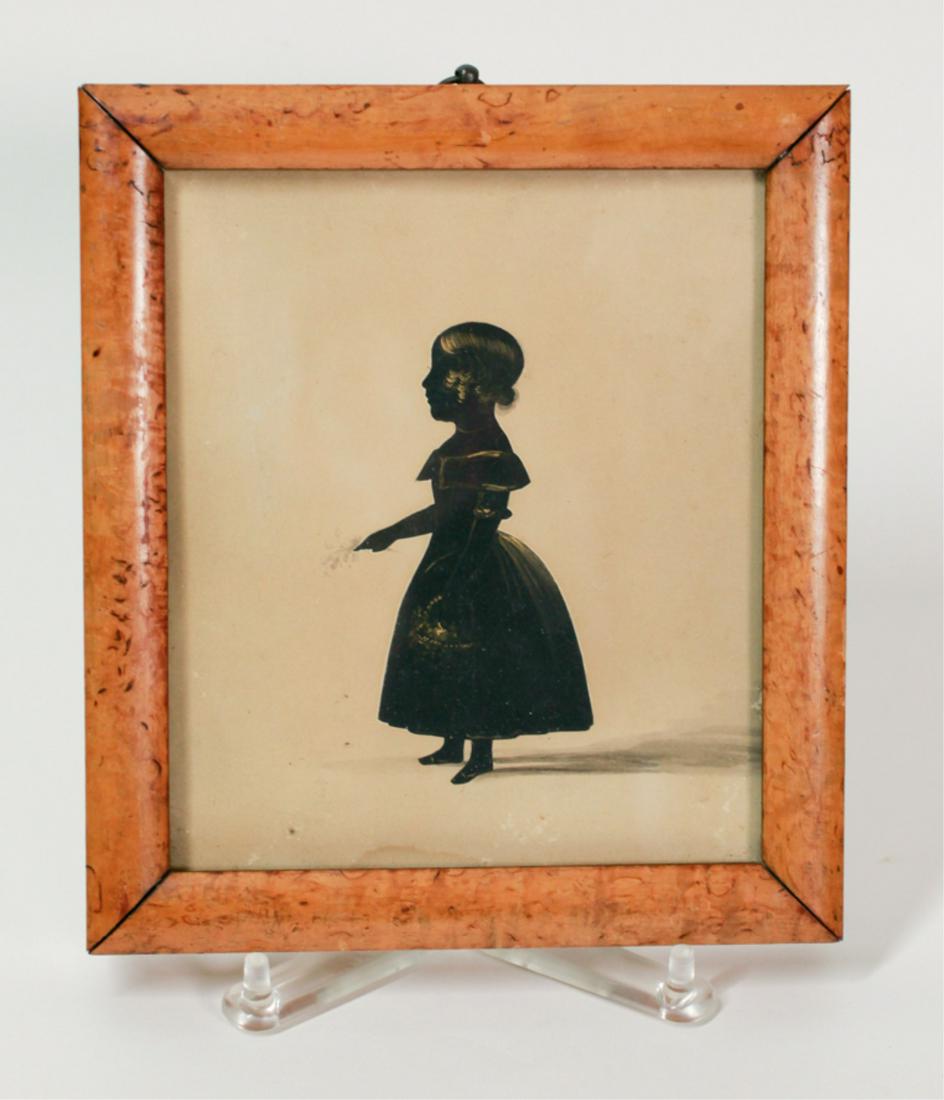 SILHOUETTE OF A YOUNG GIRL: Early 19th century, full length depicting a young girl holding flowers, bronze highlights and watercolor enhancements, in a bird's eye maple frame, sight size, 5 x 6 inches, frame, 7.5 x 6.75 inches