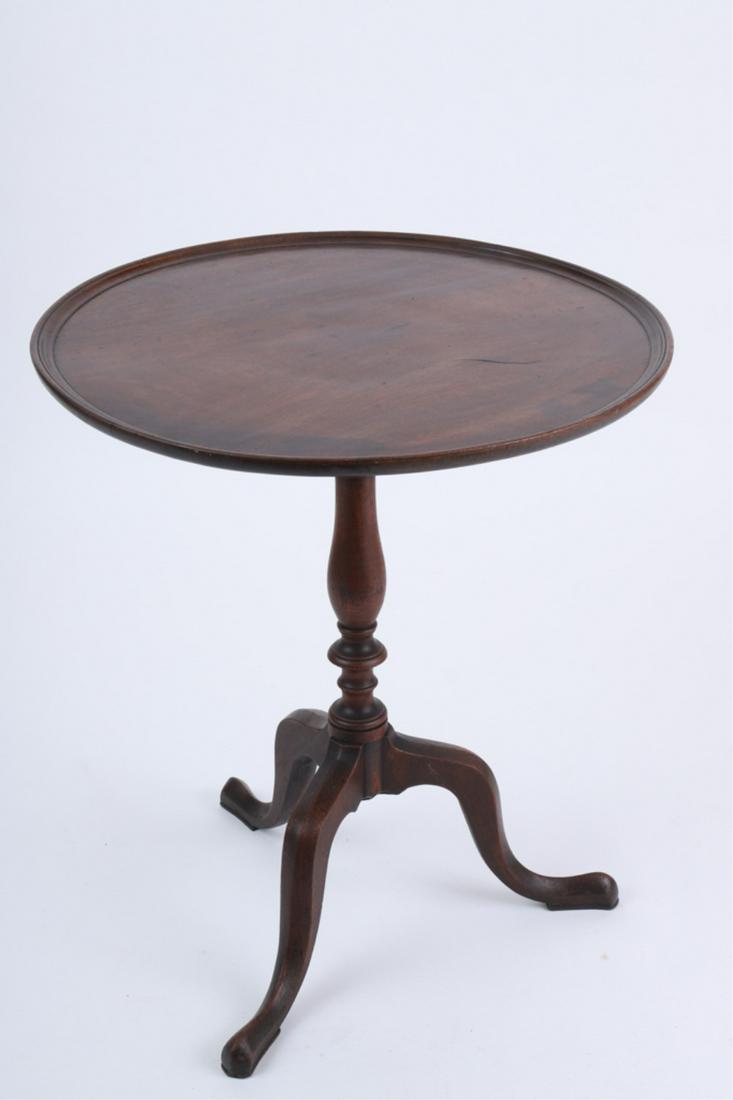 NEW ENGLAND QUEEN ANNE TEA TABLE: Having dished circular tilt-top above a ringed standard, raised on tripod snake feet, retains a Alvin C. Detweiler, Washington, D.C. antiques dealer label, 27 x 23.25 inches