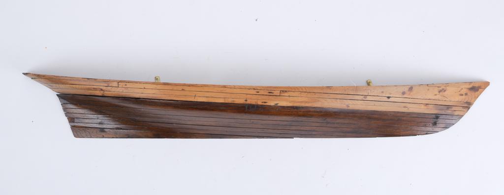 19TH CENTURY HALF-HULL MODEL: Twelve laminates in two tones of wood, 52.5 inches long