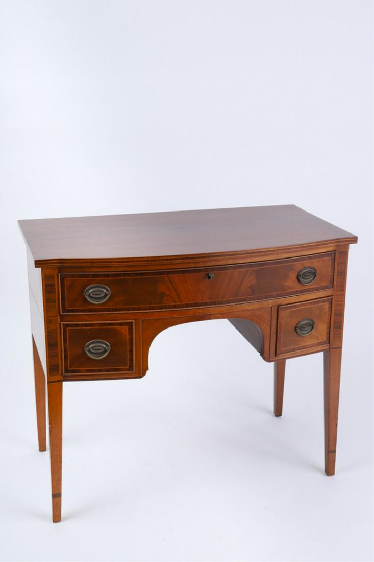 DIMINUTIVE NEW ENGLAND FEDERAL MAHOGANY SERVER: Bowed front, with rosewood banded inlays, three cockbeaded drawers consisting of a long drawer over two short drawers flanking the case that is centered with an arched skirt, raised on square taper le