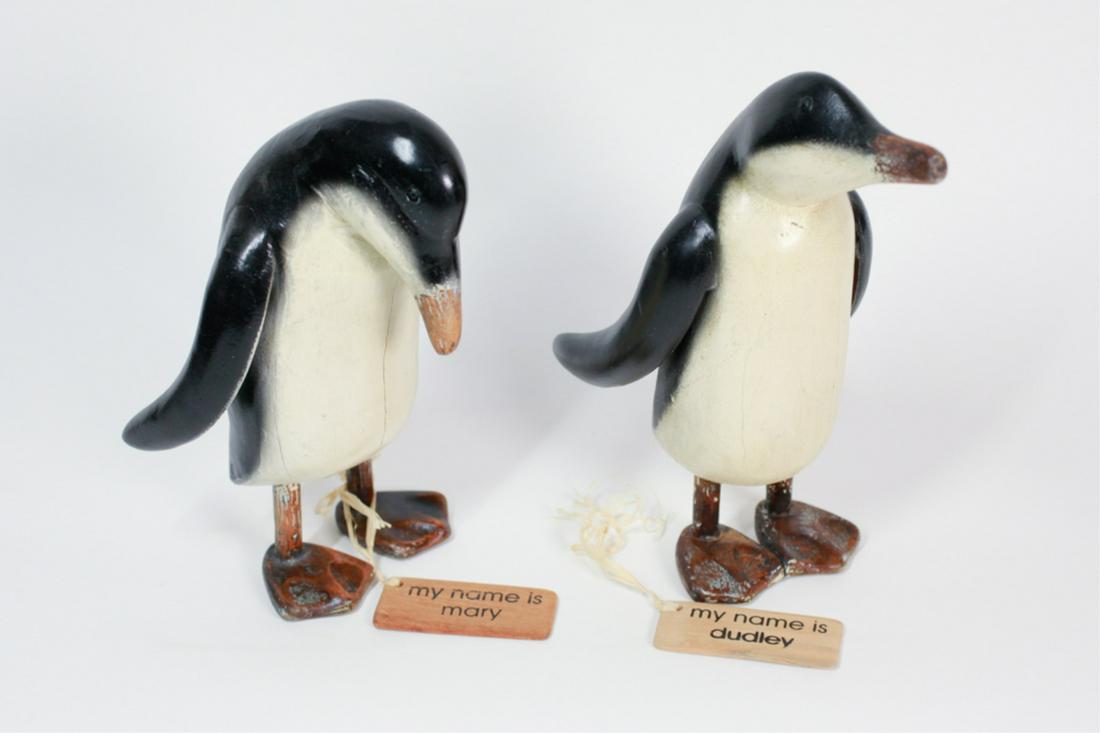 PAIR OF CARVED WOOD PENGUINS: Last quarter of the 20th century, one looking ahead, one looking down, tallest 10 inches