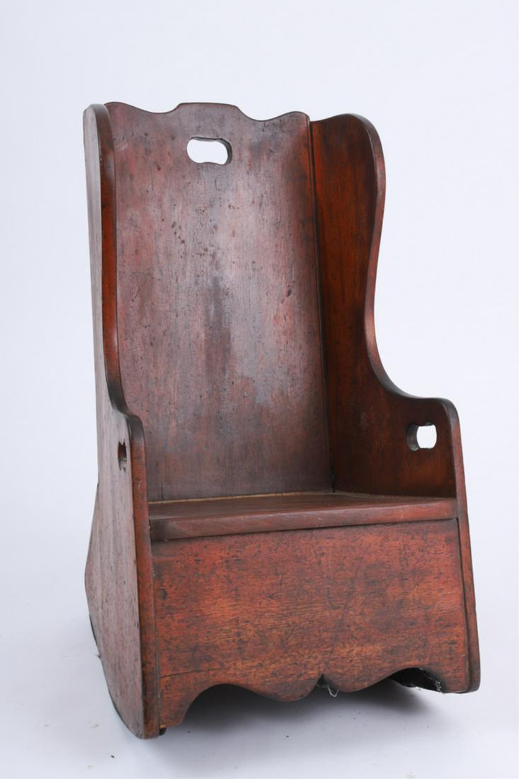 NEW ENGLAND BIRCH CHILD'S WING BACK ROCKER: Early 19th century, red stained, cut-out handholds, canted sides, shaped crest and apron, 25 14.5 x 16.5 inches