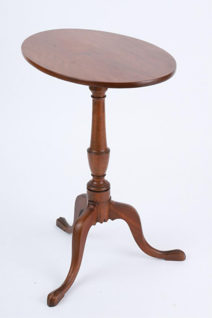 COLONIAL TILT-TOP STAND, ATTRIBUTED JOSEPH SHORT: Flame birch with oval top above a ring and urn standard, with tripod snake legs ending in pointed shaped pad feet, 27.5 x 22.5 x 16 inches