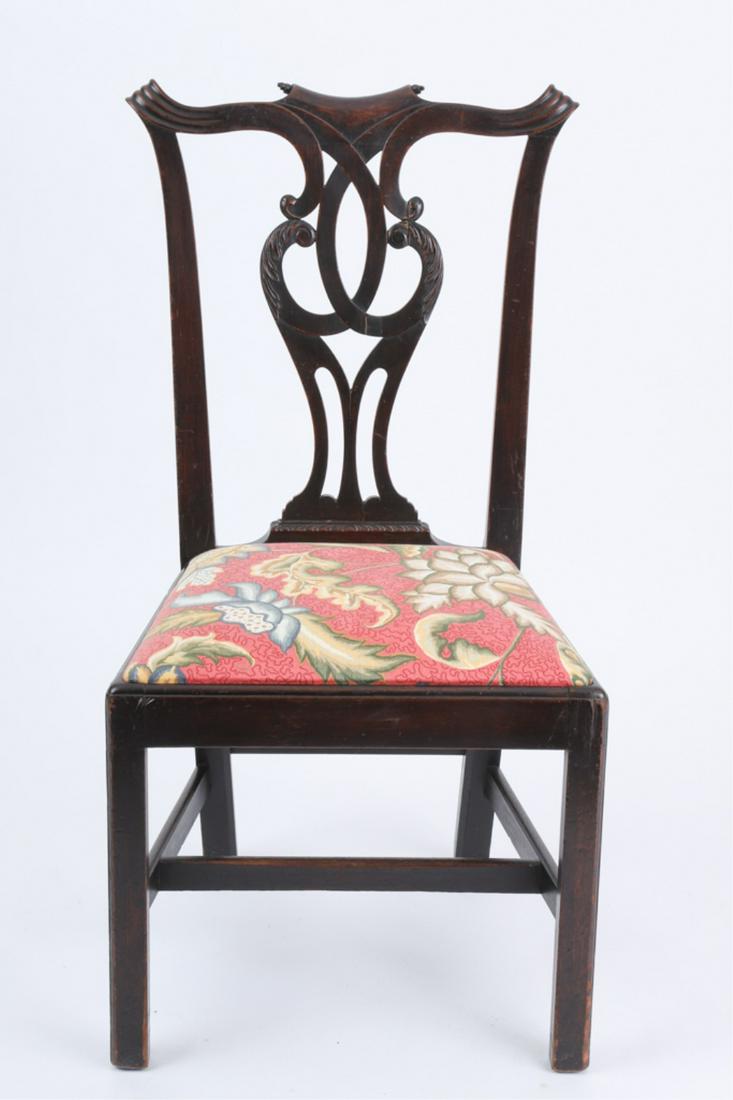 GEORGE III CHIPPENDALE MAHOGANY SIDE CHAIR: Carved crest with scroll ears, interlaced carved and pierced splat above a trapezoidal slip seat, raised on Marlborough legs joined by stretchers, 38 x 20 x 18 inches