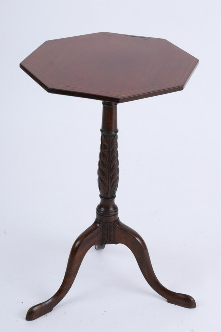 FEDERAL MAHOGANY INLAID CANDLESTAND: Octagonal top with double string inlay, raised on a turned standard with acanthus leaf carved, above s tripod base with snake feet, late 18th century, 25 x 15.25 x 15.5 inches
