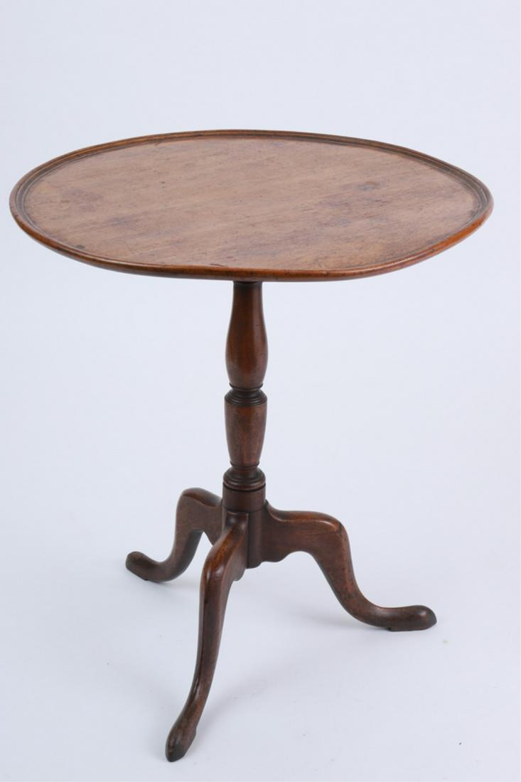 (18th C) ESSEX COUNTY MAHOGANY TEA TABLE: Attributed to James Rayner of Newburyport, dished circular tilt-top above a ring and urn standard, over tripod snake feet, 28.5 x 25.5 inches
