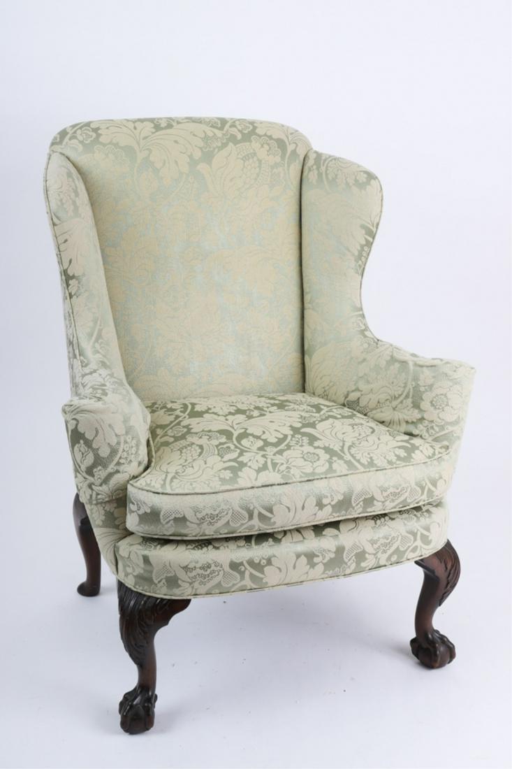 CHIPPENDALE STYLE WING CHAIR: Last quarter of the 19th century, rolled arms and bowed seat rail, raised on fine carved cabriole legs ending in ball and claw feet, upholstered in a green damask, 40 x 33 x 26 inches