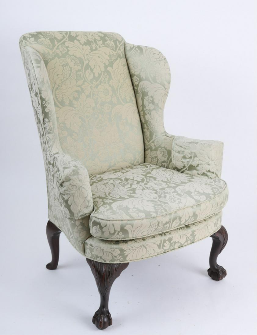 CHIPPENDALE STYLE WING CHAIR: Last quarter of the 19th century, rolled arms and bowed seat rail, raised on fine carved cabriole legs ending in ball and claw feet, upholstered in a green damask, 43 x 35 x 26 inches