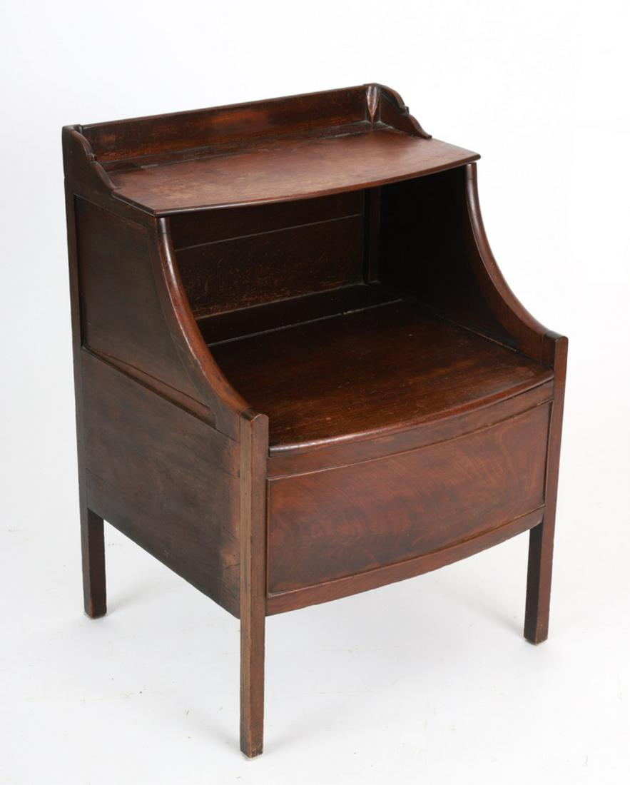 GEORGE III CHAMBER CABINET: Mahogany with bowed front, hinged top and lifting seat to reveal a chamber pot, 30 x 21 x 19 inches