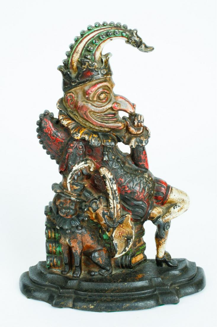 CAST IRON PUNCH DOORSTOP: Circa 1910, punch seated on books with dog at his side, 13 inches high