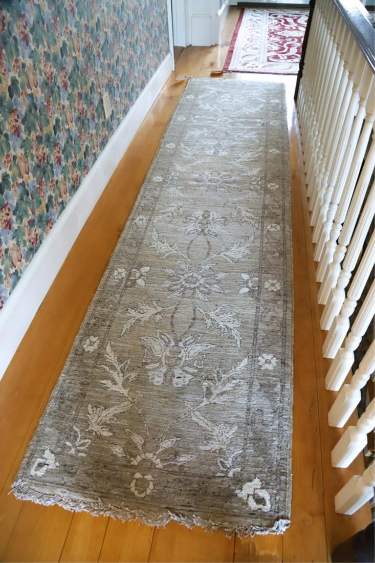 MODERN PAKISTAN ORIENTAL HAND MADE RUNNER: With all over floral design and ivory repeating flowers. 11 feet 6 inches x 2 feet 10 inches. The carpet is modern, purchased in the last 20 years.