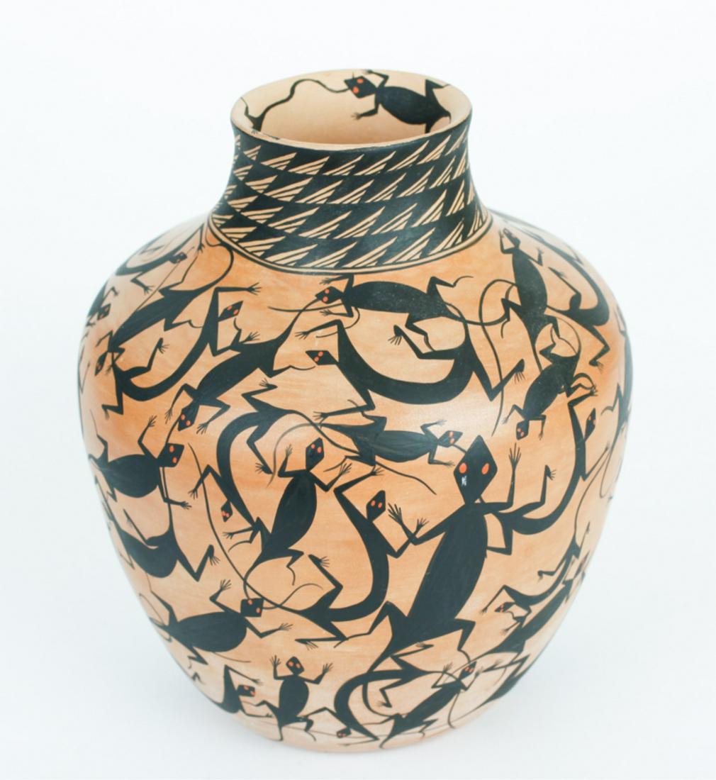 SUN & FIRE JEMEZ PUEBLO POT: By Sal & Flo Yepa, decorated in horned lizards with red eyes, with two in the interior rim, geometric bands, signed and titled on the base, 8 x 7 inches