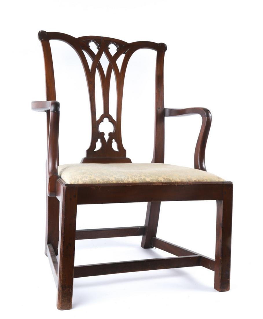 (18th c) CHIPPENDALE MAHOGANY ARMCHAIR: Arched crest rail with carved and pierced trefoils and brackets. Interlaced carved and pierced back splat, shaped arms, upholstered drop seat and straight molded legs supported with an "H" stretcher. 
