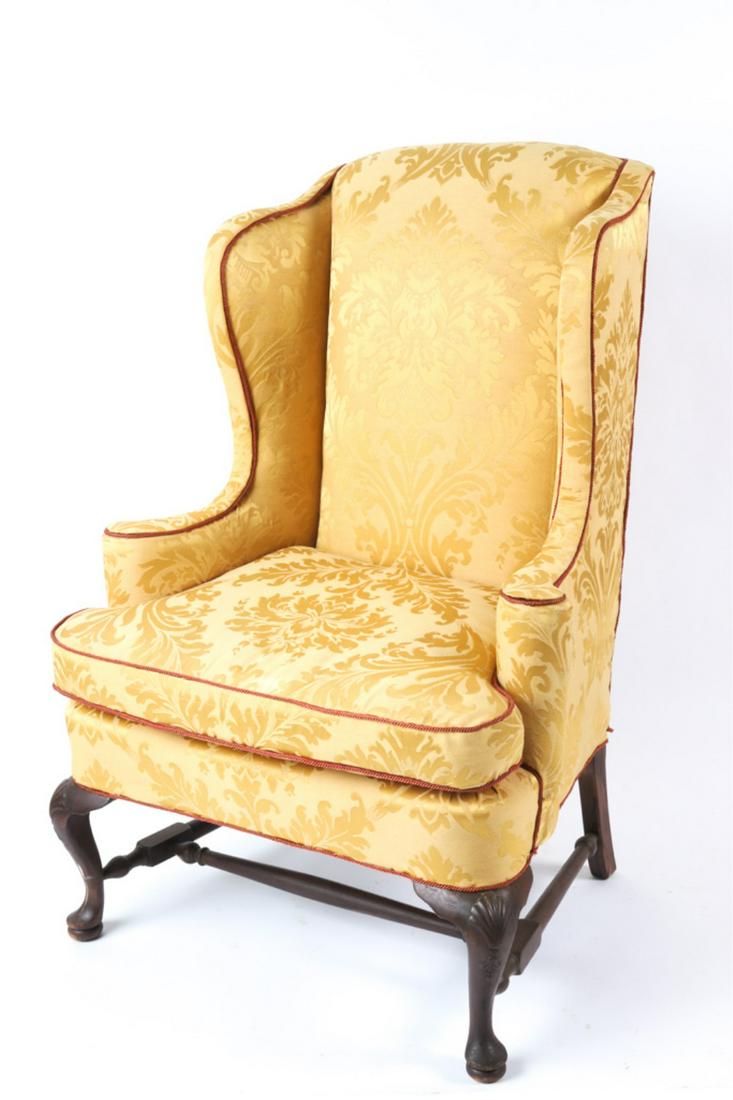 (19th c) QUEEN ANNE STYLE EASY CHAIR: Nicely upholstered in gold damask with red rope piping raised on cabriole legs with shell carved knees and pad feet supported by block and vase turned H stretcher. 47 x 32 x 31 inches. Condition: Good