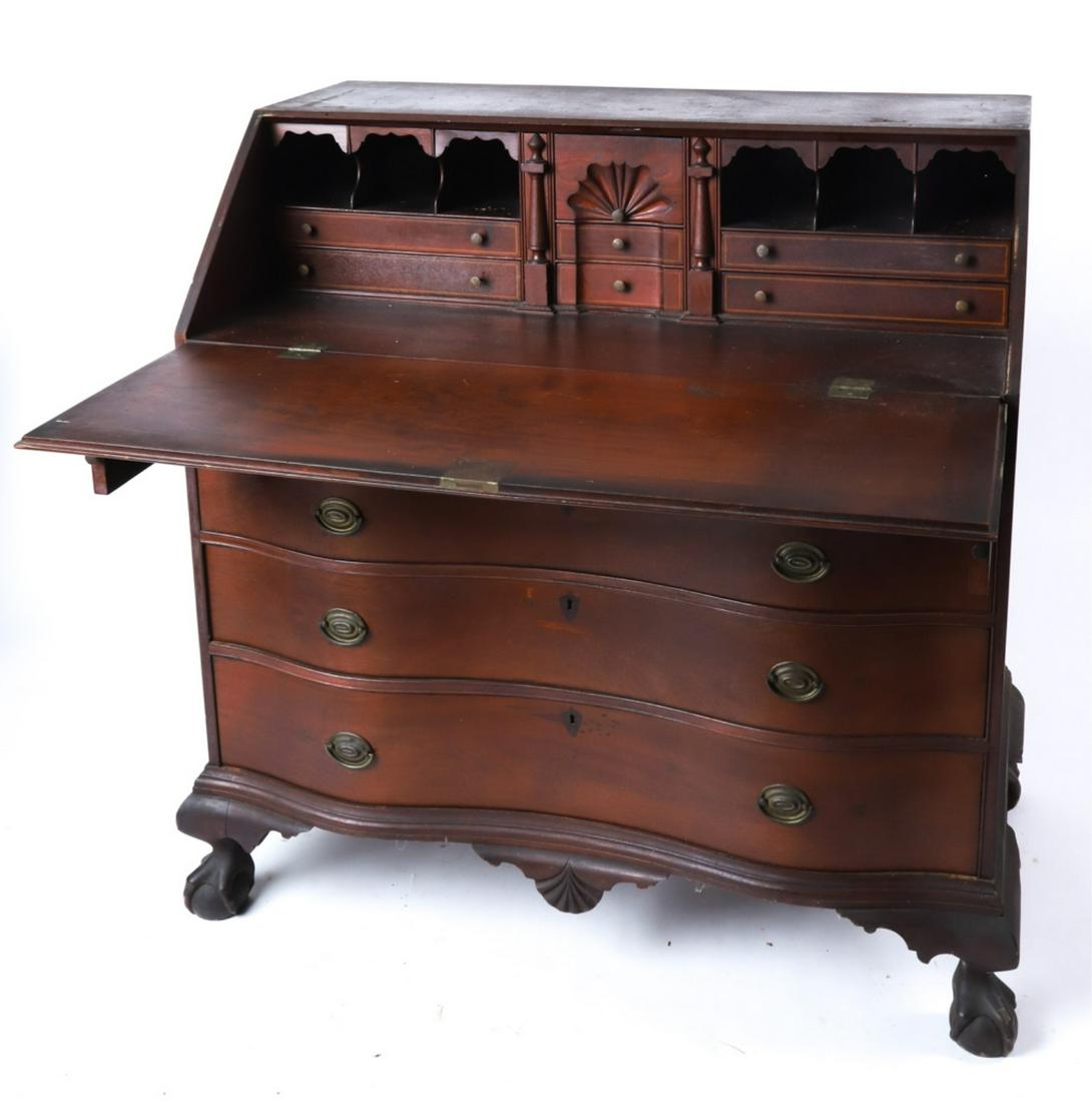 CHIPPENDALE RESTORED PERIOD SERPENTINE FRONT DESK: Mahogany fall front opens to an array of pigeon holes and drawers with tape inlay and shell carved interior, the center drawer having been carved with a shell. Below contains (4) graduating drawers, m