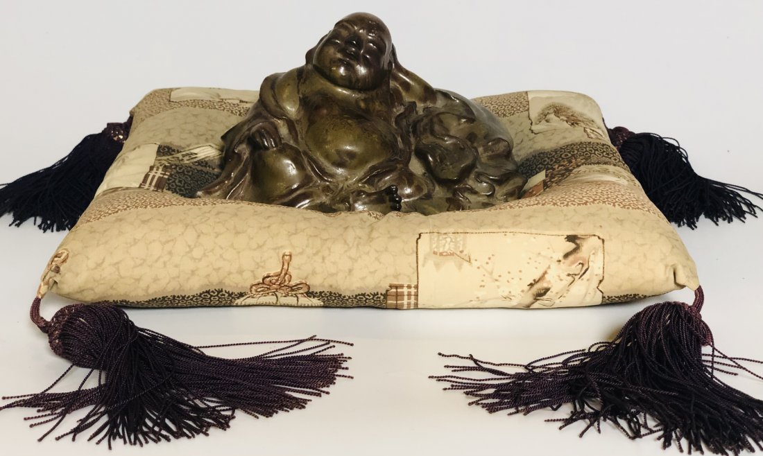 (18th/19th c) JAPANESE STONEWARE FIGURINE of HOTEI: Glazed earthenware. signed under base. 4 x 7 x 5 inches. (not including tasseled pillow). Note: 1967 Bill of Sale identifies the artist as Chotarow (Chokarow?). Condition: Good Temp No 6014