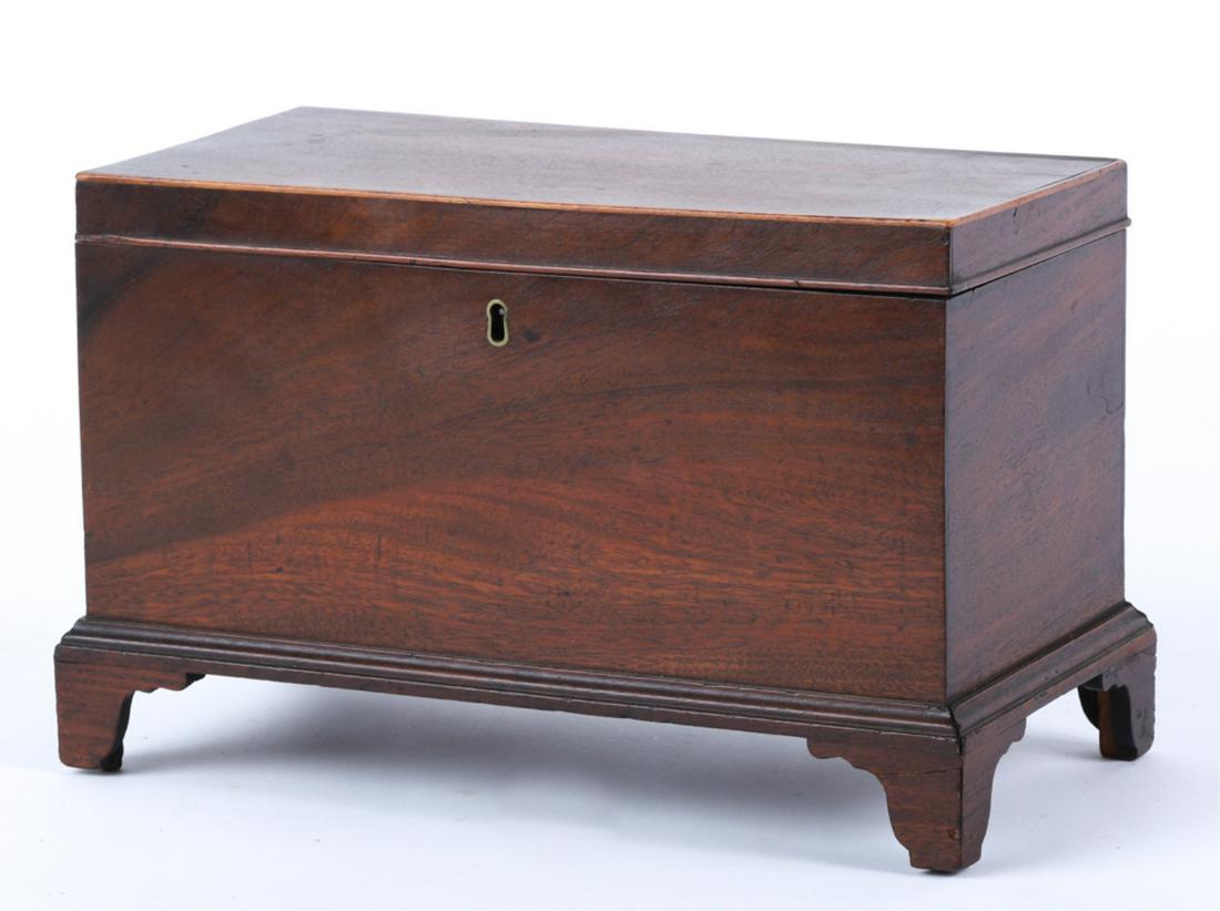 CHIPPENDALE MAHOGANY CADDY: String inlaid molded cover opens to a single compartment. Box raised on a molded base with bracket feet. 8 x 12 x 6 1/2 inches Condition: Good, repair to front left foot, rear foot supported. Interior
