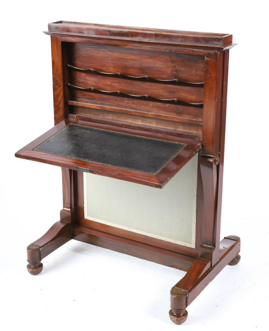 AMERICAN MAHOGANY OCCASIONAL DESK with FIRESCREEN: Fall front desk on frame opens to (3) racks and a padded writing surface is supported by scrolled brackets on a shell carved trestle base and turned feet. Upholstered fire screen slides up from behind