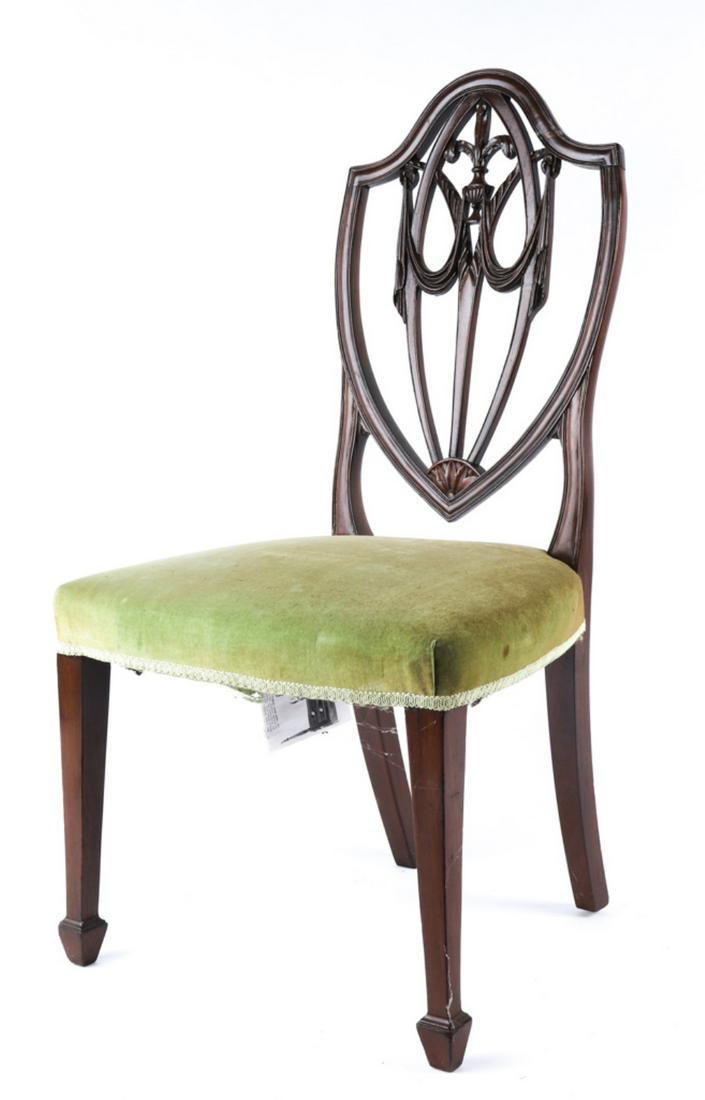 HEPPLEWHITE MAHOGANY SHIELD BACK SIDE CHAIR: Drapery carved splat with vase and plume carved centers. Tapered reeded legs terminating with spade feet. 39 x 21 x 17 inches. Probably New York 1780-1800. Condition: Repair to crest Temp No 6303