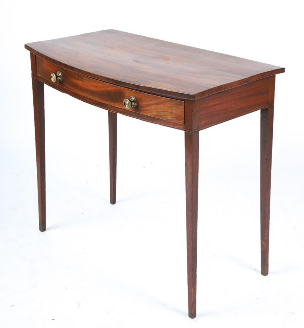 HEPPLEWHITE MAHOGANY BOW FRONT (1) DRAWER TABLE: Drawer with brass pulls and string inlay. Tape inlay along bottom edge of apron. 30 x 34 x 19 inches. Condition: Good, minor scattered finish wear and inconsistencies Temp No 6159