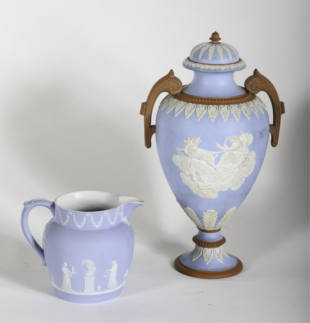 BATES WALKER CO & WEDGWOOD JASPERWARE: Bates Waller Co. urn with Greek gods and acanthus leaves on a terra cotta base. The Wedgwood creamer with trees, swags and Helenistic figures. 12 and 4 3/4 inches. Condition: Urn c1875 has surface gri