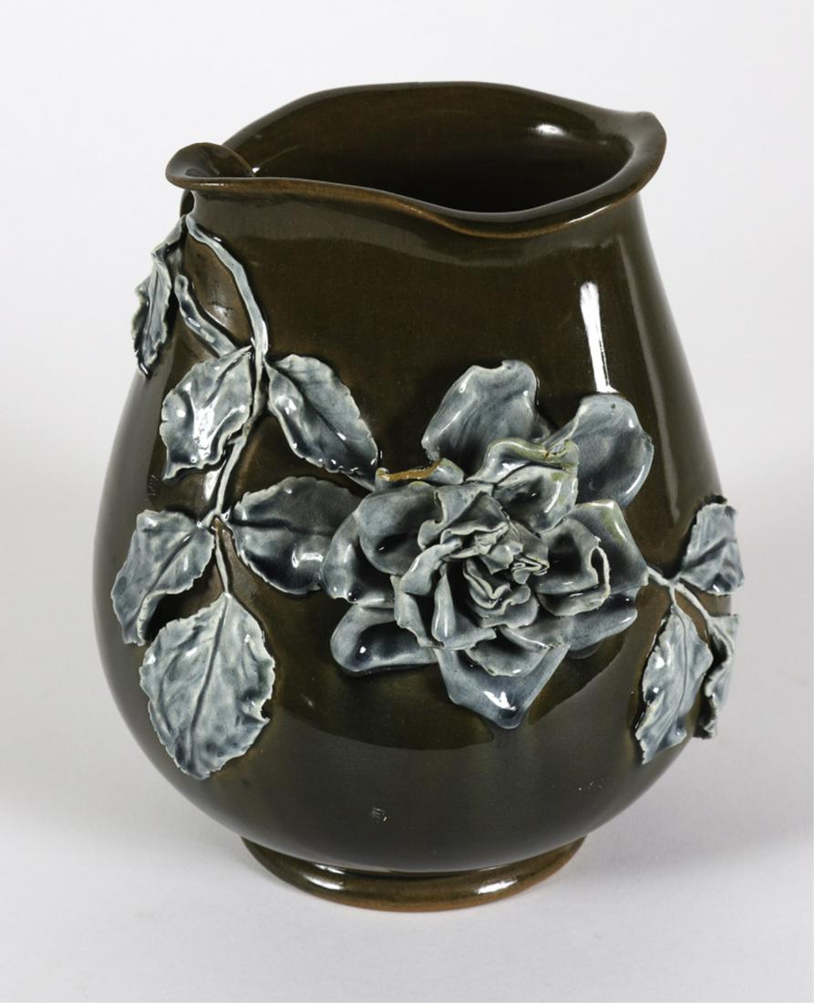CHELSEA KERAMIC ART WORKS VASE by JOSEPHINE DAY: Bulbous vase decorated by Josephine Day with an applied rose branch in blue-grey glaze on olive green ground. stamped CKAW and JD. 6 3/4 x 5 1/2 inches (Josephine Day was Hugh Robertson's sister-in-la