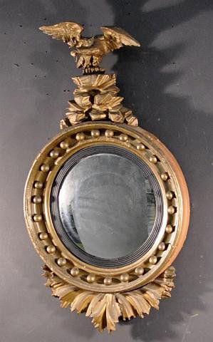 Period bull's eye mirror with carved eagle crest: Period girandole bull's eye mirror with carved eagle crest. Height: 33 1/2 in. Width: 18 1/2 in.