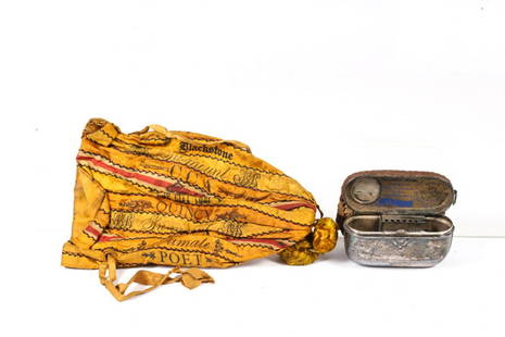 CIGAR RIBBON PURSE and TOBACCO POUCH: (1) Draw purse made from stitched cigar ribbons with silk pompom drop. 10 1/2 inches and (1) 1862 Ridgewood tobacco matchbox with strike and tobacco pouch. 5 x 3 3/4 inches.