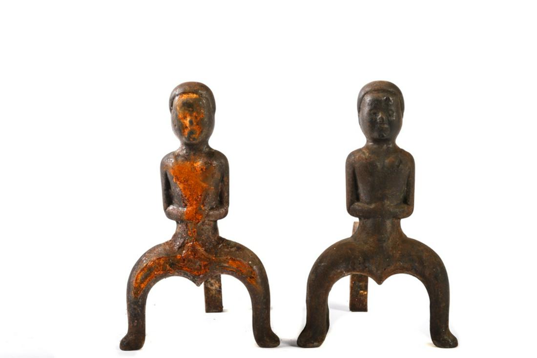 PAIR OF "NAUGHTY NELLIE" PUDDLE CAST ANDIRONS: 11 1/2 x 7 x 11 inches.