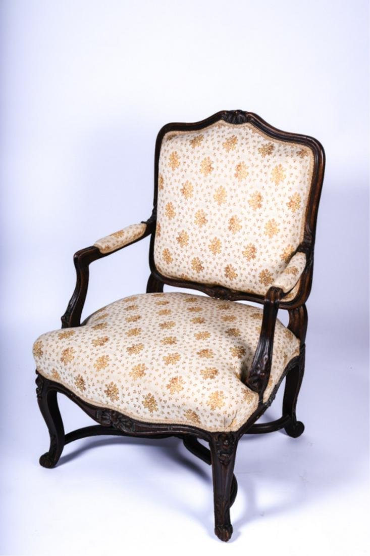 LOUIS XV STYLE FRUITWOOD ARMCHAIR: Late 19th century, floral carved frame, open arms, raised on cabriole legs joined by stretcher, 39 x 27 x 24 inches