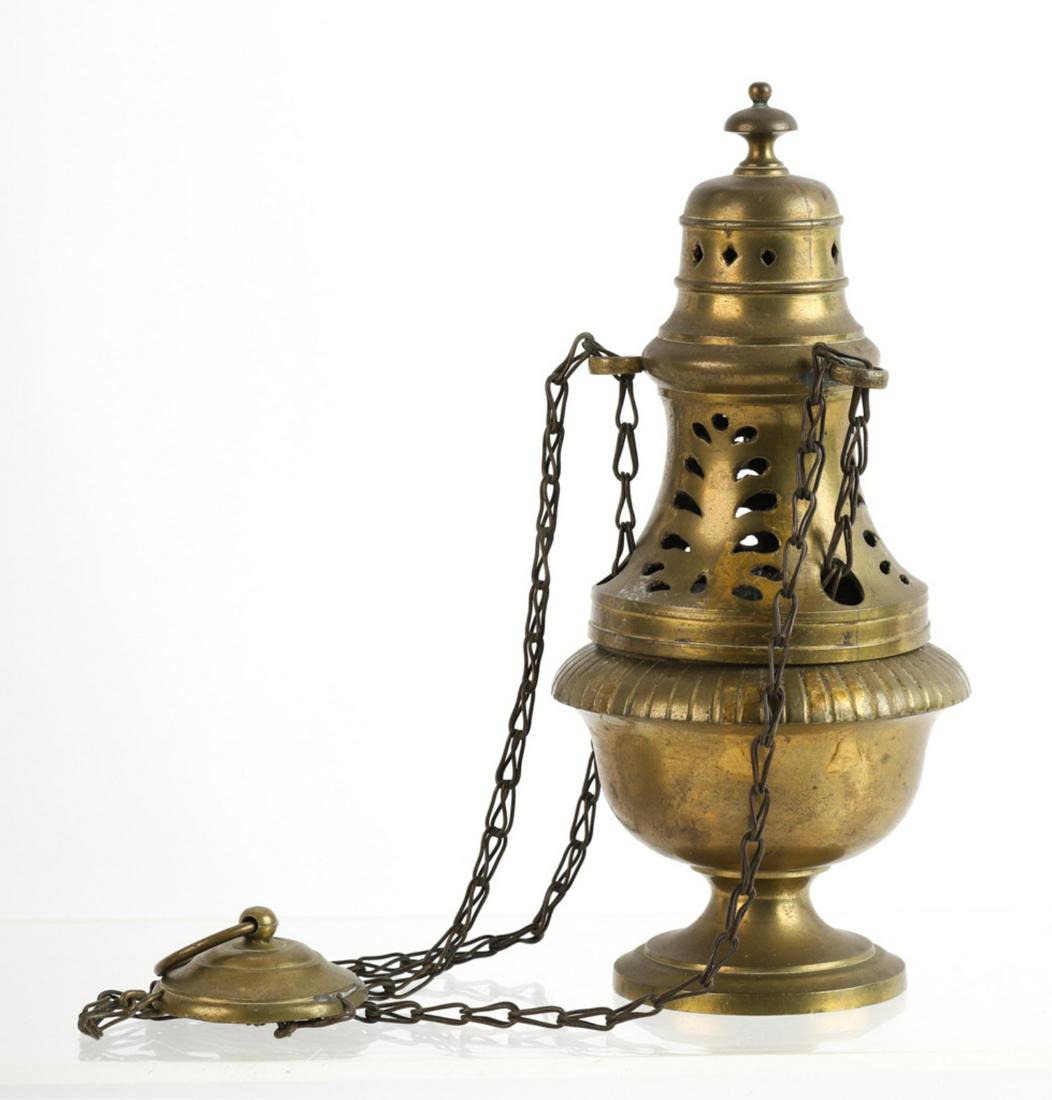 HANGING BRASS CENSER FROM A MARBLEHEAD CHURCH: Pierced brass chimney and urn-form font suspended by (3) chains and ringed escutcheon to hang. 24 inches (fully extended)