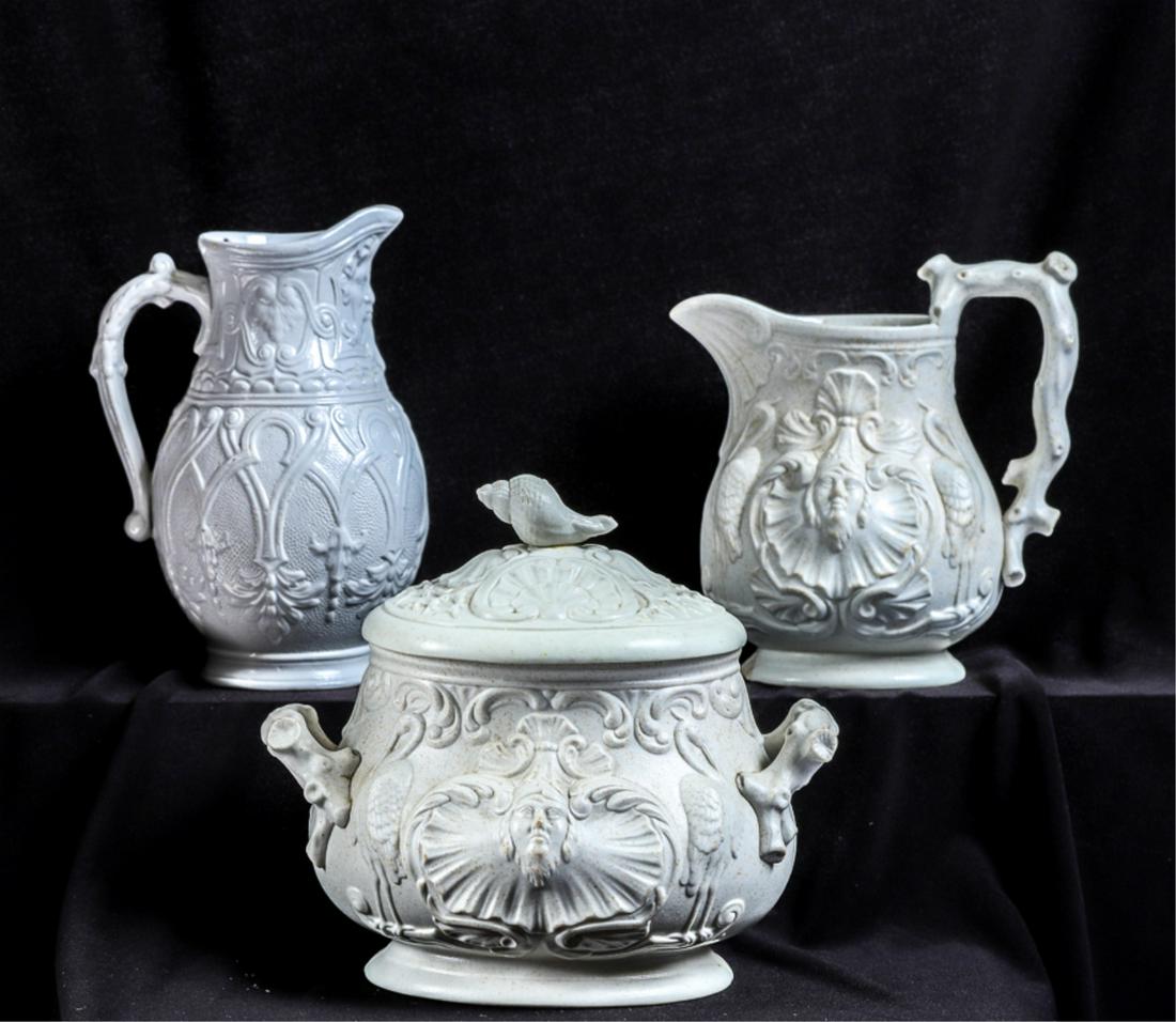 ENGLISH SALT GLAZED CREAMERS & SUGAR BOWL: Creamer and sugar with shell crane and mermaid motif. 5 and 6 inches. The single creamer is embossed with the north wind and other aesthetic movement motifs. 6 inches