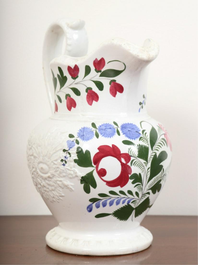 (19th c) ADAMS ROSE PITCHER: Embossed with raised basket of flowers and floral spray. 8 3/4 inches.