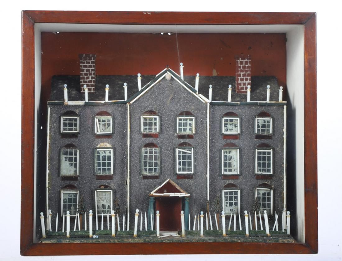 ENGLISH GLASS SHADOW BOX HOUSE circa 1819: Covered in pulverized glass called "diamond dust", milk glass rods, blue milk glass posts and windows. Ruby glass door, window decorations and finials. Presented in a dovetailed mahogany case. 14 x 17