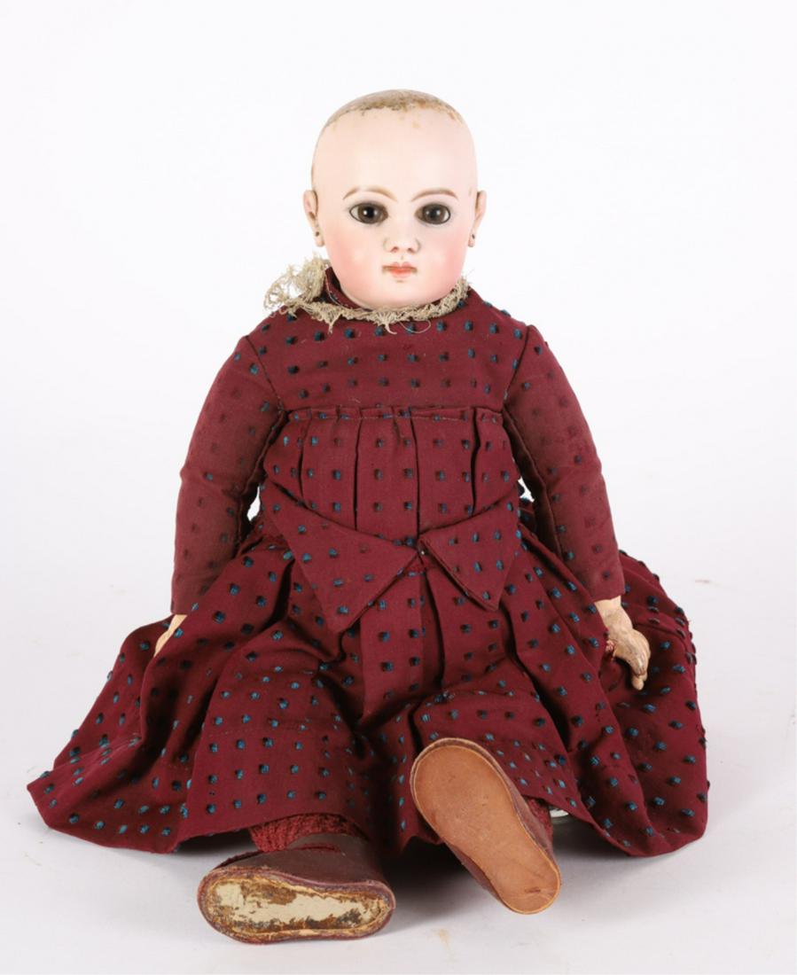 FRENCH E.J. JUMEAU BISQUE HEAD DOLL: Articulated composition arms and legs with original clothing. embossed Depose E.J. 8 on back of head. 4 inch head. 18 inches overall.