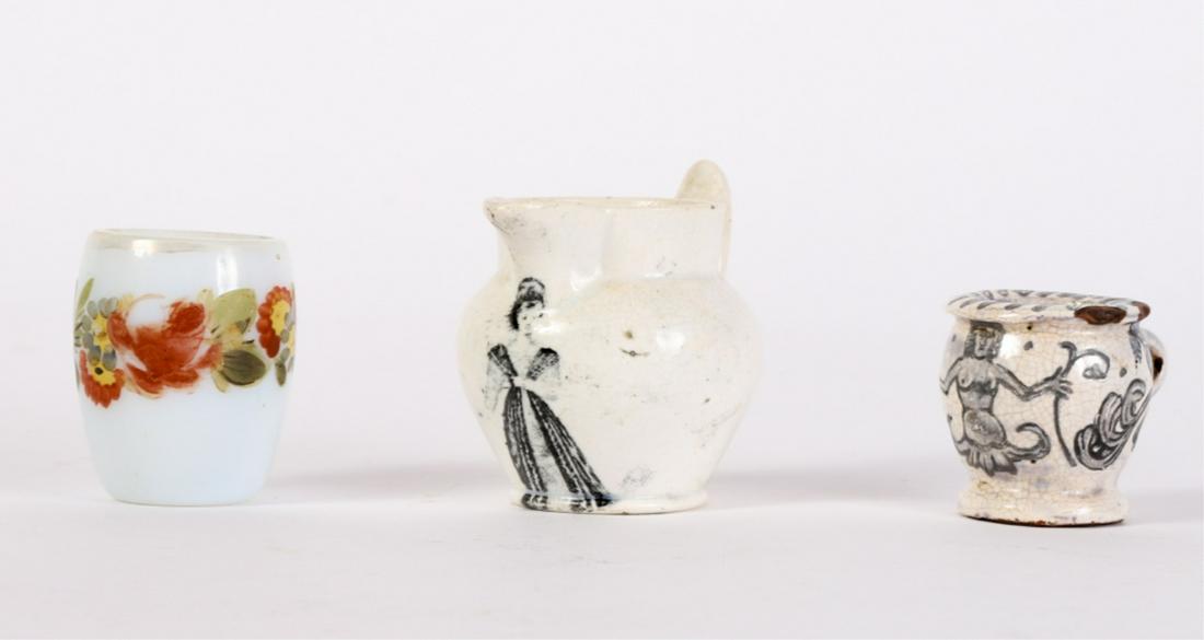 (2) MINIATURE MUGS AND (1) MINIATURE PITCHER: Milk glass mug with applied handle is decorated with a floral motif. An early redware mug decorated with a mermaid and a Staffordshire picture with a transfer decoration of a woman. 2 1/4 inches (and