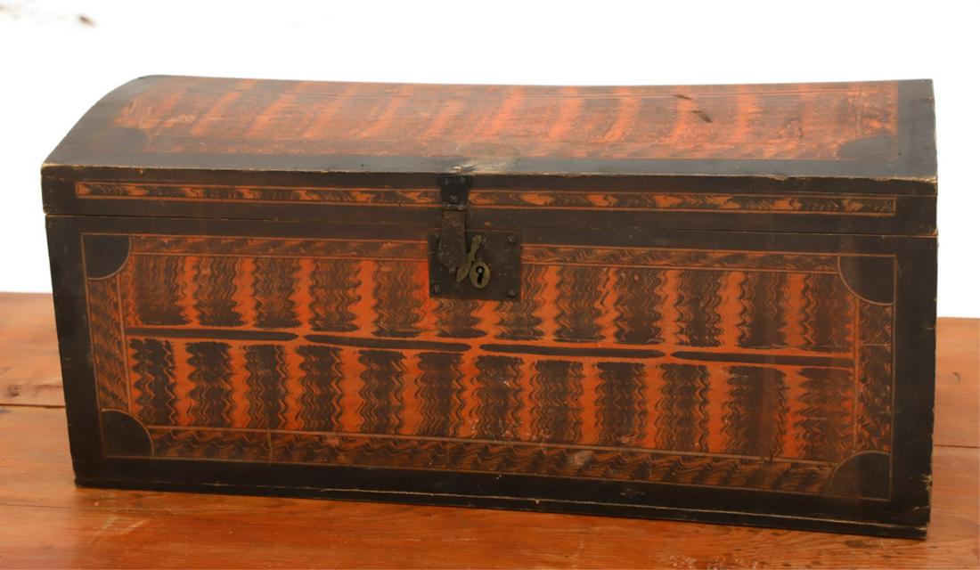 (19th c) GRAIN DECORATED DOME TOP CHEST: Black border surrounds a salmon ground with black comb-work waves. Original iron lock and snipe hinges. 13 x 29 x 14 inches.