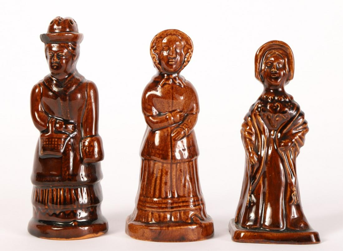 (3) ROCKINGHAM POTTERY SALT AND PEPPER SHAKERS: Including a matching set of a man and woman and a third. 5 3/4 inches (and under)