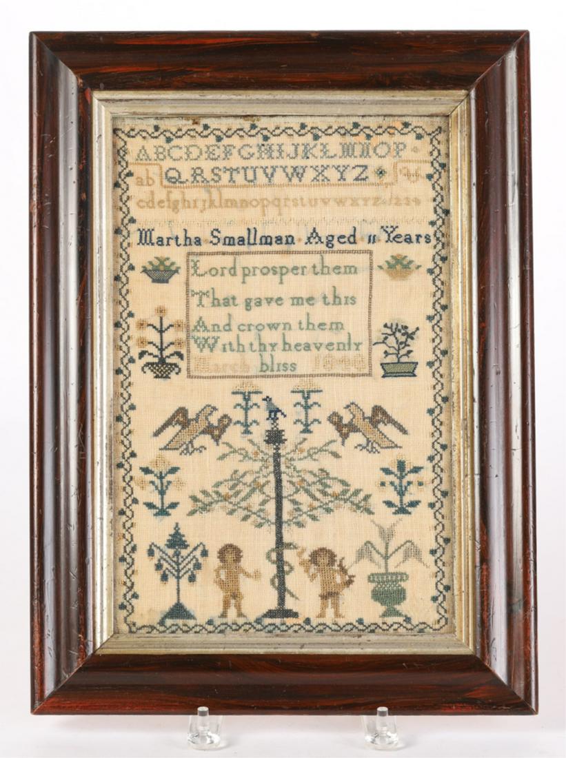 ADAM & EVE NEEDLEWORK SAMPLER by MARTHA SMALLMAN: Alphabet sampler by Martha Smallman aged 11 years, dated March 1848 with motto verse framed by a running floral border and adorn with baskets of fruit, flowers, birds, snake and Adam and Eve. . 12 1/2