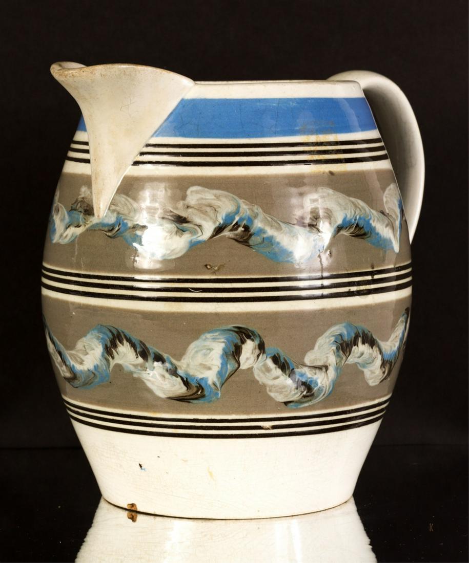 BRITISH BARREL-FORM MOCHAWARE PITCHER: Glazed pearlware decorated with blue, brown and putty bands and earthworm patterns. 8 inches