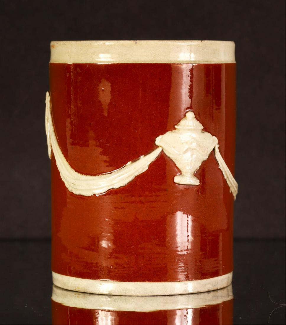 ENGLISH CREAMWARE MOURNING MUG: Chestnut field with raised urn and drapery. 3 5/8 inches